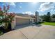 Attached garage with gray doors and a large concrete driveway at 365 N Spaulding Cv, Lake Mary, FL 32746