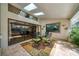 Covered patio adjacent to the pool with seating and skylights at 365 N Spaulding Cv, Lake Mary, FL 32746