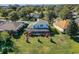 Aerial view showcasing home's backyard oasis, featuring a screened pool and lush landscaping at 3898 Beacon Ridge Way, Clermont, FL 34711