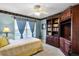 Bedroom with a single bed, built-in shelving, and light blue walls at 3898 Beacon Ridge Way, Clermont, FL 34711