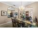 Bright dining room with a large glass-top table and decorative accents at 3898 Beacon Ridge Way, Clermont, FL 34711