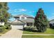 Two-story house with a gray roof, white garage door, and lush landscaping at 3898 Beacon Ridge Way, Clermont, FL 34711