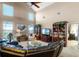 Relaxing living room featuring a sectional sofa, built in shelving, and large windows at 3898 Beacon Ridge Way, Clermont, FL 34711