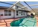 Relaxing screened pool area with lounge chairs and a spacious deck at 3898 Beacon Ridge Way, Clermont, FL 34711