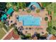 Large rectangular pool with surrounding lounge chairs and umbrellas at 3898 Beacon Ridge Way, Clermont, FL 34711