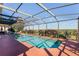 Large screened pool with a view of the surrounding landscape at 3898 Beacon Ridge Way, Clermont, FL 34711