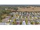 Aerial view of residential neighborhood with houses and mature trees at 392 Arbella Loop, The Villages, FL 32162