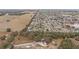 Aerial view of homes and landscape with large open space nearby at 392 Arbella Loop, The Villages, FL 32162