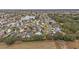 Aerial view showing neighborhood homes, landscaping, and a lake at 392 Arbella Loop, The Villages, FL 32162