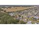 Aerial view showcasing neighborhood homes nestled amongst lush trees at 392 Arbella Loop, The Villages, FL 32162