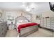 Spacious bedroom with a king-size bed and plenty of dresser storage at 392 Arbella Loop, The Villages, FL 32162