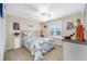 Cozy bedroom with a queen bed and a ceiling fan at 392 Arbella Loop, The Villages, FL 32162