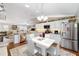 Well-lit dining area with white table and chairs near the kitchen at 392 Arbella Loop, The Villages, FL 32162