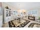 Spacious dining room featuring a large area rug and decorative china cabinet at 392 Arbella Loop, The Villages, FL 32162