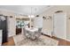 Charming dining area with white table and chairs, located near the kitchen at 392 Arbella Loop, The Villages, FL 32162