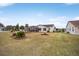 Landscaped backyard of the home features a screened patio at 392 Arbella Loop, The Villages, FL 32162