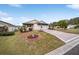 Charming single-story home with landscaped yard and paver driveway at 392 Arbella Loop, The Villages, FL 32162