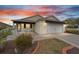 House exterior featuring a 2-car garage and landscaped front yard at 392 Arbella Loop, The Villages, FL 32162