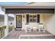 Front porch with seating area and awning at 392 Arbella Loop, The Villages, FL 32162