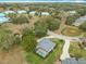 Aerial view of a home with a screened pool and a well-manicured lawn at 39656 Harbor Hills Blvd, Lady Lake, FL 32159