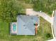 Aerial view of home showcasing landscaping, screened pool, and extended driveway, creating an inviting curb appeal at 39656 Harbor Hills Blvd, Lady Lake, FL 32159