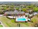 Aerial view of the community clubhouse with a pool, golf course, and lush landscaping at 39656 Harbor Hills Blvd, Lady Lake, FL 32159