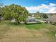 Aerial view of a well-manicured lawn and backyard with a screened-in pool enclosure at 39656 Harbor Hills Blvd, Lady Lake, FL 32159