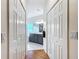 Hallway view with access to a bright bathroom featuring a double vanity and a shower stall at 39656 Harbor Hills Blvd, Lady Lake, FL 32159