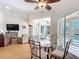 Open-concept breakfast nook featuring a glass table, flowing into the living area at 39656 Harbor Hills Blvd, Lady Lake, FL 32159