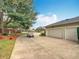 Long driveway leading to a spacious two-car garage; golf cart included at 39656 Harbor Hills Blvd, Lady Lake, FL 32159