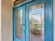 A close up of a blue front door with decorative glass and metal hardware at 39656 Harbor Hills Blvd, Lady Lake, FL 32159