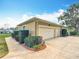 Spacious two-car garage with additional parking, manicured landscaping and concrete driveway at 39656 Harbor Hills Blvd, Lady Lake, FL 32159