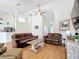 Living Room featuring hardwood floors, neutral paint, ceiling fan, and modern furniture at 39656 Harbor Hills Blvd, Lady Lake, FL 32159