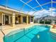 Beautiful screened-in pool area with covered patio and outdoor dining space at 39656 Harbor Hills Blvd, Lady Lake, FL 32159