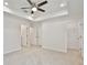 Spacious bedroom with ceiling fan, neutral carpeting, and a large closet at 40210 Orange Cir, Lady Lake, FL 32159