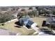 Aerial view of house showcasing large lot and solar panels at 409 Silver Maple Rd, Groveland, FL 34736