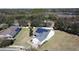 Aerial view of a house with solar panels, showcasing a large backyard and neighborhood at 409 Silver Maple Rd, Groveland, FL 34736