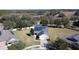 Aerial view of house with a large backyard and solar panels at 409 Silver Maple Rd, Groveland, FL 34736