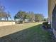 Large backyard with grassy lawn and privacy wall at 409 Silver Maple Rd, Groveland, FL 34736