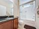 Bathroom with granite vanity, tub, and shower at 409 Silver Maple Rd, Groveland, FL 34736