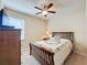 Bedroom with carpeted floor, wood furniture, and ceiling fan at 409 Silver Maple Rd, Groveland, FL 34736