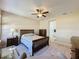 Comfortable bedroom with ensuite bathroom access and large windows at 409 Silver Maple Rd, Groveland, FL 34736