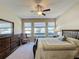 Bright bedroom with large windows and wood furniture at 409 Silver Maple Rd, Groveland, FL 34736