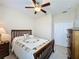 Bedroom with wood furniture, ceiling fan and window coverings at 409 Silver Maple Rd, Groveland, FL 34736