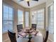 Bright breakfast nook with a glass table and wicker chairs, surrounded by windows at 409 Silver Maple Rd, Groveland, FL 34736