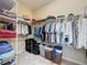 Walk-in closet with ample shelving and hanging space at 409 Silver Maple Rd, Groveland, FL 34736