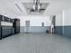 Garage with epoxy flooring and storage cabinets at 409 Silver Maple Rd, Groveland, FL 34736