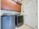 Laundry room with washer, dryer and upper cabinets at 409 Silver Maple Rd, Groveland, FL 34736