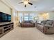 Spacious living room with large windows and neutral decor at 409 Silver Maple Rd, Groveland, FL 34736