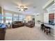 Open living room showcasing ample natural light at 409 Silver Maple Rd, Groveland, FL 34736